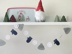 a shelf with christmas decorations and gnomes on it