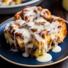 a piece of cinnamon roll with icing on a blue plate