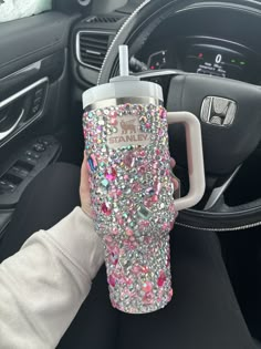 a person holding a cup in their car