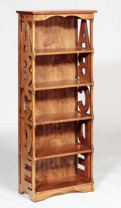 a wooden bookcase with the letters abc and person carved into it's sides