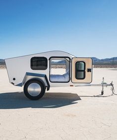 an off road camper trailer parked in the desert