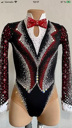 a bodysuit with sequins and a red bow tie