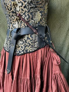 a woman's corset is shown with leather straps on the waist and belt