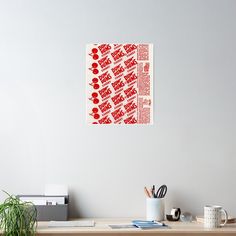 a red and white pattern on a wall above a desk