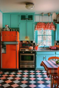 an orange refrigerator and stove in a kitchen with checkered flooring on the floor