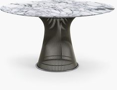 an oval marble table with metal base