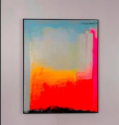 a painting hanging on the wall in front of a white wall with an orange and red color scheme