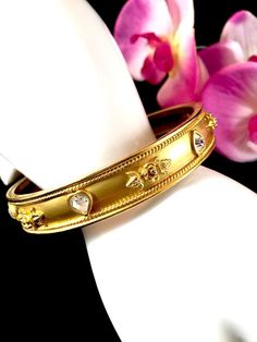 "Vintage ELIZABETH TAYLOR Signed Gilt Gold Tone & Swarovski Crystal Heart Flowers Bangle Bracelet Designer High Fashion Women's Jewelry Description Fabulous ELIZABETH TAYLOR signed vintage bangle bracelet with ice rhinestones hearts and gold tone roses \" Love Blooms\" collection. Stunning estate bracelet is 1/2\" tall and has a 2 7/8\" opening. This bangle bracelet is in excellent \" like new \" condition. FAST SHIPPING FROM A SMOKE FREE HOME! Inv.#16561" Heart Flowers, Vintage Bangle Bracelets, Swarovski Crystal Hearts, High Fashion Women, Vintage Style Earrings, Vintage Bangles, Womens Jewelry, Rhinestone Heart, Elizabeth Taylor