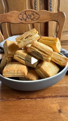 a bowl filled with cut up cookies on top of a wooden table