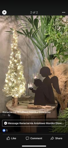 an image of a person holding a wine glass in front of a christmas tree with lights on it