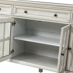 a white cabinet with glass doors and drawers