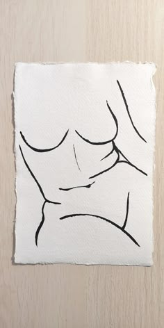 a white piece of paper with black ink on it and a drawing of a woman's breast