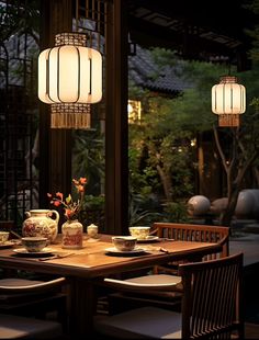 a dining room table with two lamps hanging over it