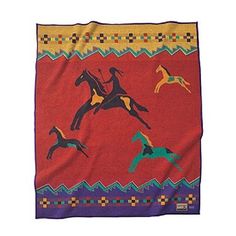 a red blanket with horses and riders on it