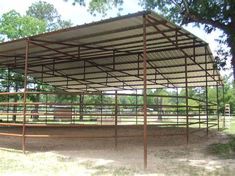 a large metal structure sitting in the middle of a field