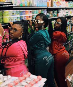 three women standing in front of a store shelf