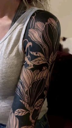 a woman with a flower tattoo on her arm