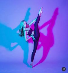 a woman in black leotard and tights is dancing with her shadow on the wall