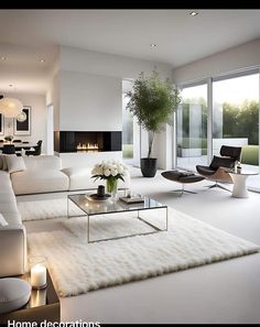 a living room with white furniture and large windows