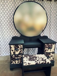 an animal print vanity with stool and mirror