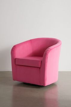 a pink chair sitting on top of a cement floor