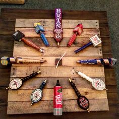 a wooden table topped with lots of different types of crafting supplies on top of it