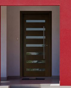 the front door to a house with red walls