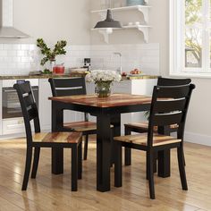 a kitchen table with four chairs around it