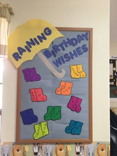 a bulletin board with an umbrella and words on it that read, raining birthday wishes