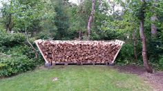 a large pile of wood sitting in the middle of a yard