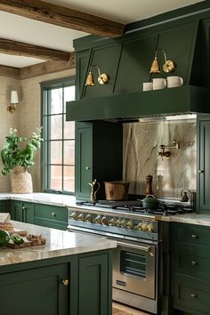 a kitchen with green cabinets and marble counter tops