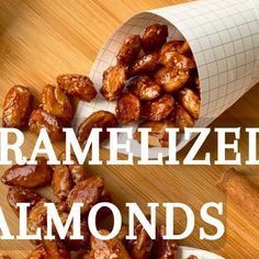 roasted almonds on a wooden table with the words caramelized almonds