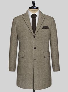 Wrap yourself in the epitome of luxury and timeless design with our Italian Highlander Stone Beige Herringbone Tweed Overcoat. Meticulously crafted from pure wool, this exquisite fabric marries unparalleled craftsmanship with the robust essence of the highlands. The subtle stone beige hue, interwoven with the classic herringbone pattern, offers a versatile and sophisticated choice for bespoke tailoring. Perfect for making a refined statement at business meetings, upscale social gatherings, or any event where sophistication is key.   The incredible overcoat will become a firm favorite as the weather cools and will ensure you stay protected. It is designed with a combination of tradition, practicality and impeccable style that makes it adaptable to almost anything in your wardrobe.  Buttons: Tweed Overcoat, Italian Suit, Linen Suits, Herringbone Tweed, Tweed Suits, Bespoke Tailoring, Herringbone Pattern, Double Breasted Suit, Wedding Suits