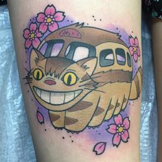 a woman's thigh with an image of a bus and cat on it