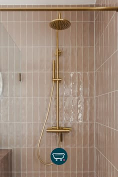 a shower head and hand held shower faucet in a bathroom with tiled walls