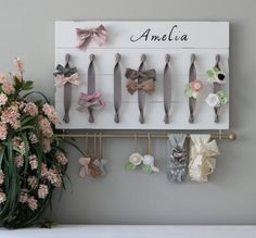 a bunch of hair clips are hanging on a wall