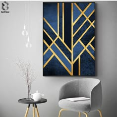 a blue and gold art piece hanging on the wall next to a table with two chairs