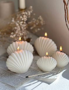 three white candles sitting on top of a table