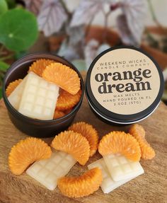 orange dream waxed wick soaps on top of a wooden board