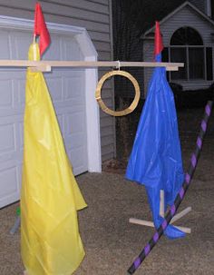 two umbrellas are hanging on a clothes line outside the house, one is upside down