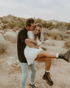 a man and woman are hugging in the desert