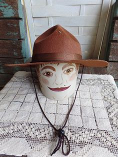 "This listing is for a Vintage Boy Scout Hat. It is made of a felt material and measures approximately 14 3/8\" in diameter. There are no markings or a size listed but the head area measures 7\" in diameter. It is in great condition with the band having a very light water mark on it. The wood head form is not for sale and was used for a prop only. Please ask any questions prior to purchasing. Thanks for looking." Adjustable Brown Felt Hat, Adjustable Brown Flat Brim Costume Hat, Vintage Adjustable Felt Hat For Rodeo, Adjustable Vintage Felt Hat For Rodeo, Adjustable Felt Hat Band For Fedora, Adjustable Felt Fedora Hat Bands, Country Style Brimmed Felt Hats, Vintage Adjustable Felt Hat For Western-themed Events, Vintage Fedora Felt Hat