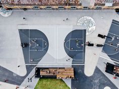 an overhead view of a basketball court with benches and people walking on the sidelines