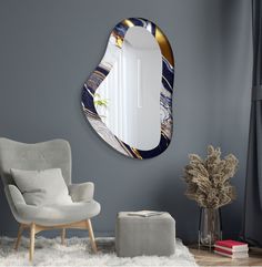 a mirror that is on the wall above a chair in a room with grey walls