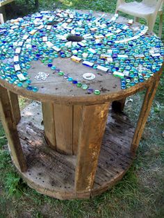 a table made out of old wine bottles