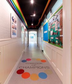 the hallway is decorated with colorful circles and posters