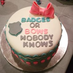 a birthday cake with the words badges or bows nobody knows on it and a pink bow