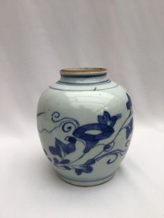 a blue and white vase sitting on top of a table