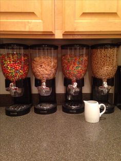 the coffee maker is filled with different types of beans and cereal in it's containers