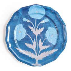 a blue plate with flowers painted on it